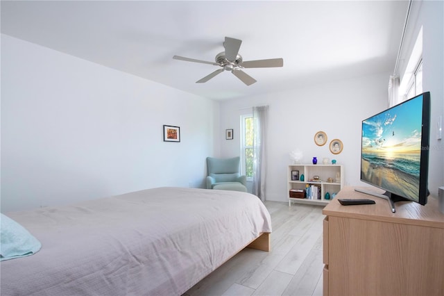 bedroom with light hardwood / wood-style floors and ceiling fan