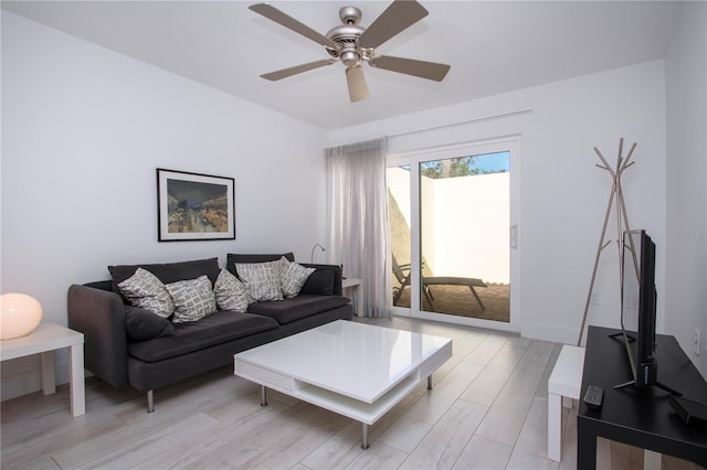 living room featuring ceiling fan and light hardwood / wood-style flooring