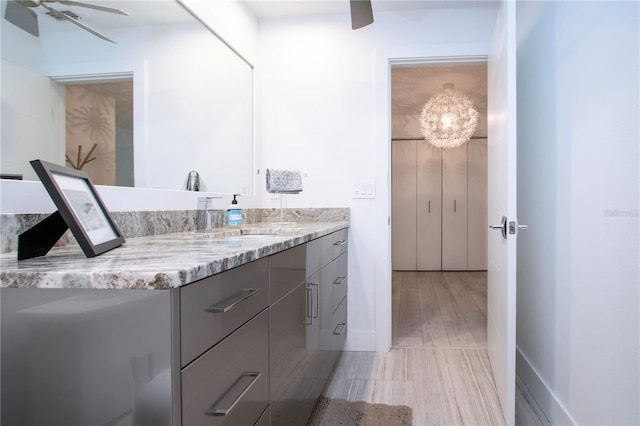 bathroom with vanity, ceiling fan, and wood-type flooring