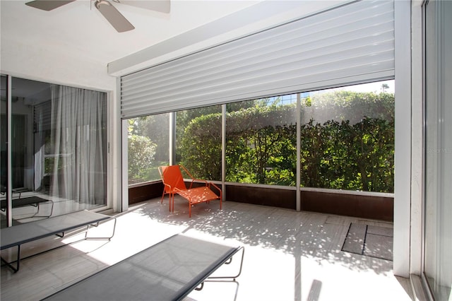 unfurnished sunroom with ceiling fan