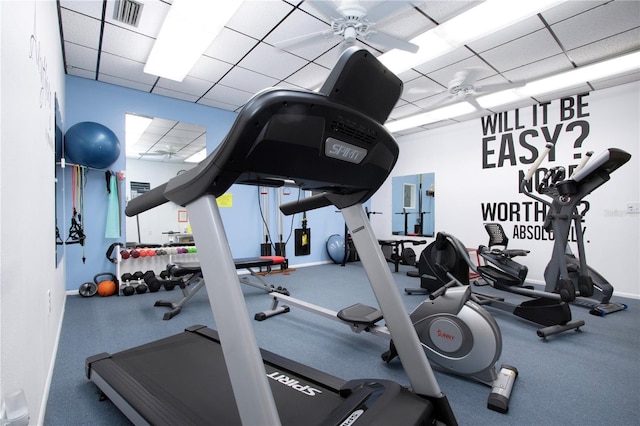 workout area featuring ceiling fan and a drop ceiling