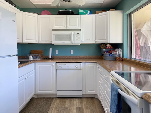 kitchen featuring light wood-type flooring, white appliances, white cabinetry, and a paneled ceiling