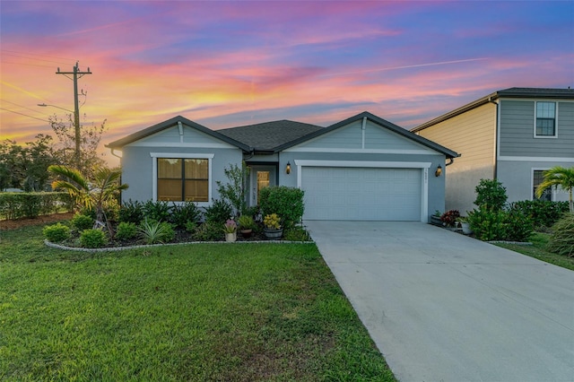 view of front of home featuring a lawn and a garage