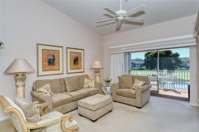 carpeted living room featuring vaulted ceiling, ceiling fan, and a textured ceiling