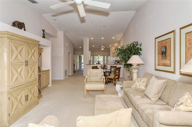 carpeted living room with ceiling fan, a textured ceiling, and vaulted ceiling