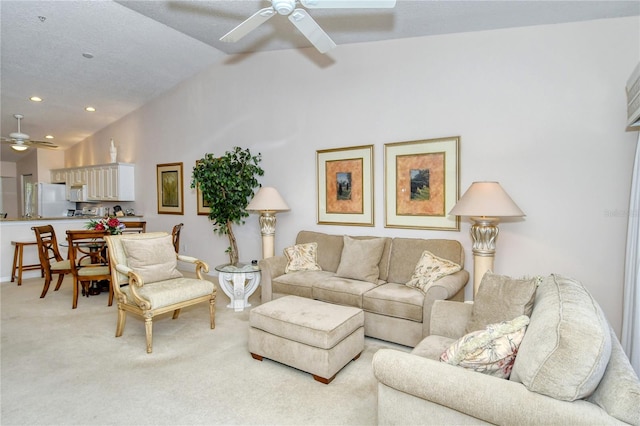 carpeted living room featuring ceiling fan and lofted ceiling