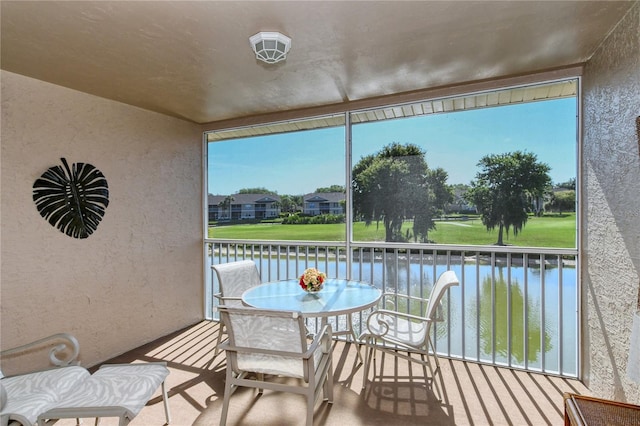 sunroom / solarium featuring a healthy amount of sunlight and a water view