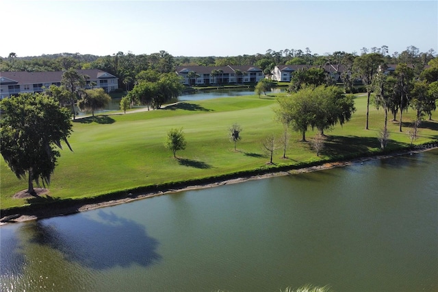 surrounding community with a yard and a water view