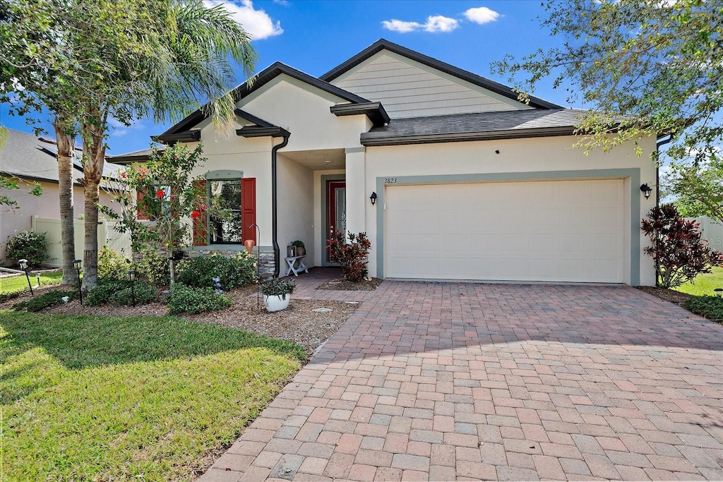 view of front of home featuring a garage and a front lawn