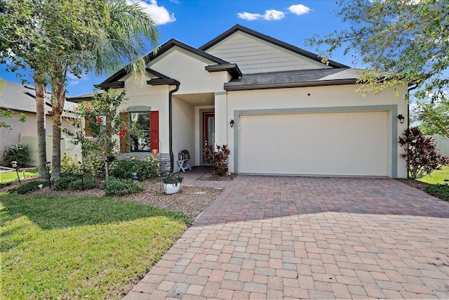 view of front of home featuring a garage and a front lawn