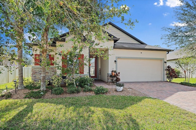 view of front of home with a garage and a front lawn