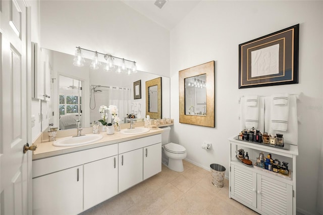 bathroom with a shower with curtain, vanity, lofted ceiling, tile patterned floors, and toilet