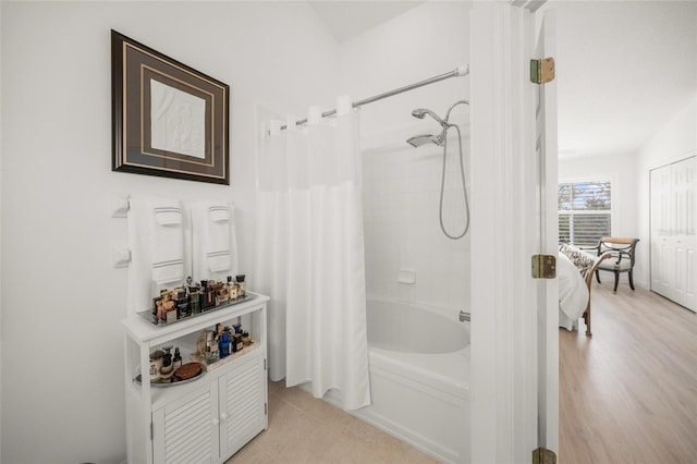 bathroom featuring shower / tub combo with curtain and hardwood / wood-style flooring