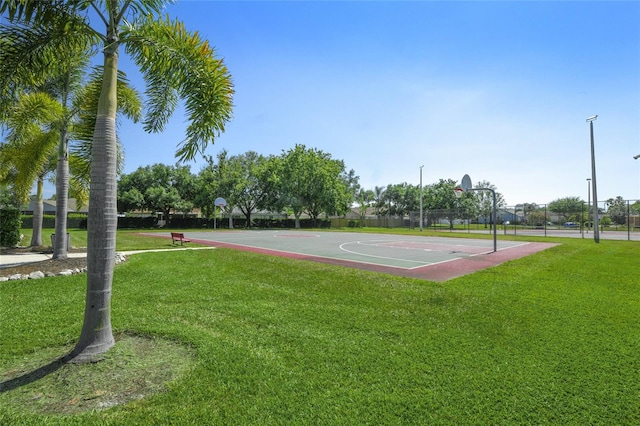 view of basketball court with a yard