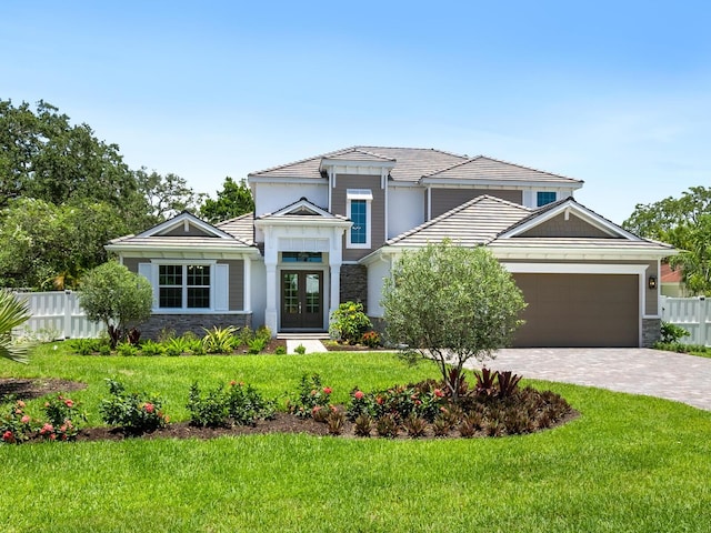 view of front of property featuring a garage and a front yard