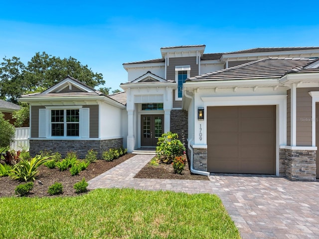 view of front of house with french doors and a garage