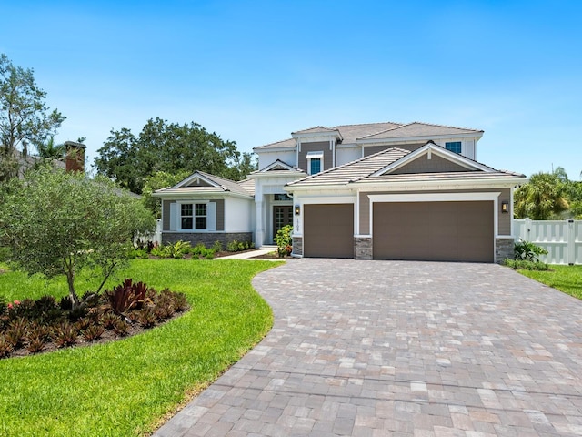 view of front facade featuring a front yard and a garage