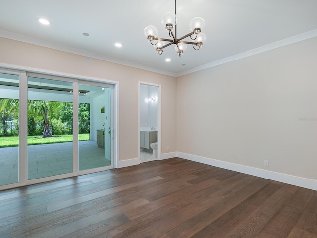 spare room with dark hardwood / wood-style floors, an inviting chandelier, and crown molding