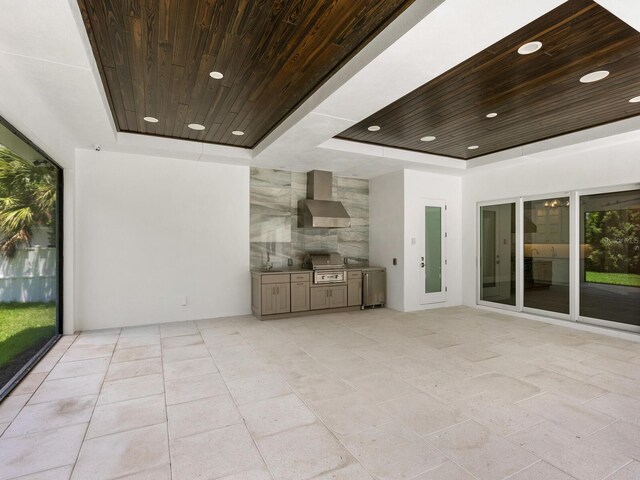 unfurnished living room featuring a tray ceiling and wooden ceiling