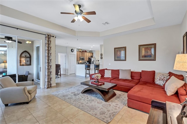 living room with ceiling fan and light tile patterned flooring