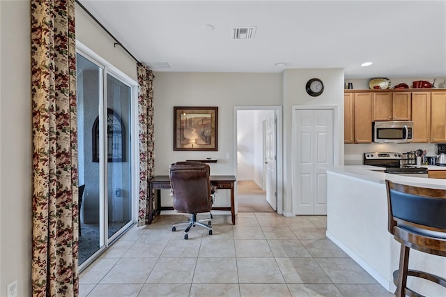 335 River Enclave Ct, Bradenton, FL 34212 - kitchen featuring appliances with stainless steel finishes, a desk, light countertops, light tile patterned flooring, and recessed lighting