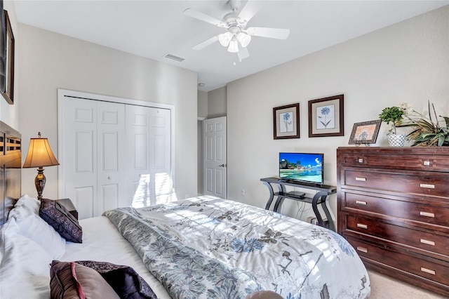 carpeted bedroom featuring a closet and ceiling fan