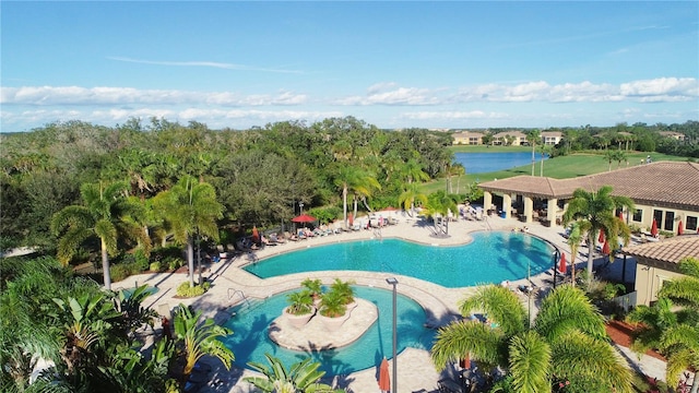 view of swimming pool with a water view and a patio