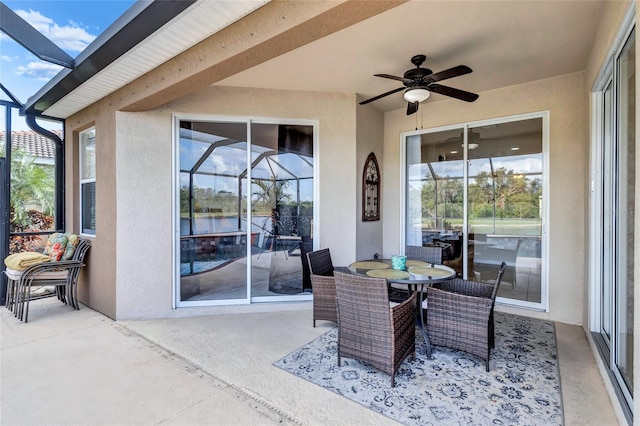 exterior space with glass enclosure and ceiling fan