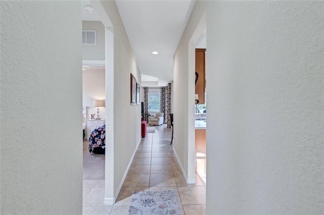 hallway with light tile patterned floors