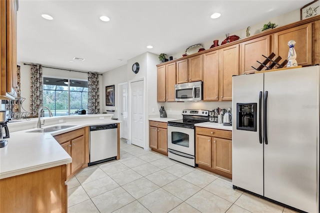 335 River Enclave Ct, Bradenton, FL 34212 - kitchen with appliances with stainless steel finishes, light countertops, light tile patterned flooring, recessed lighting, and brown cabinetry