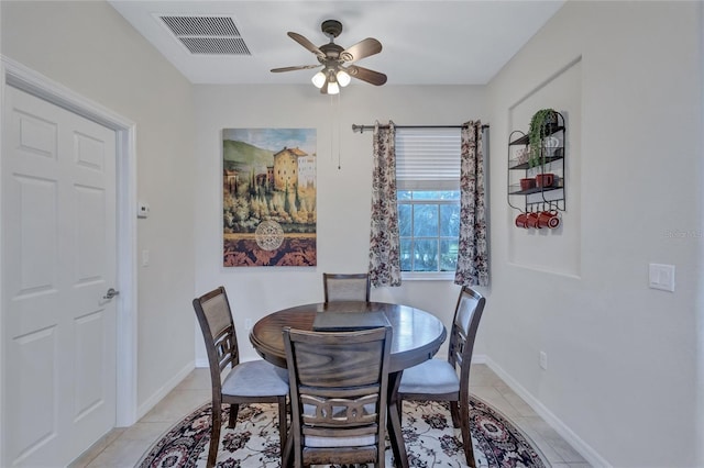 tiled dining area with ceiling fan