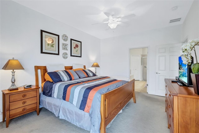 bedroom with connected bathroom, ceiling fan, and light colored carpet