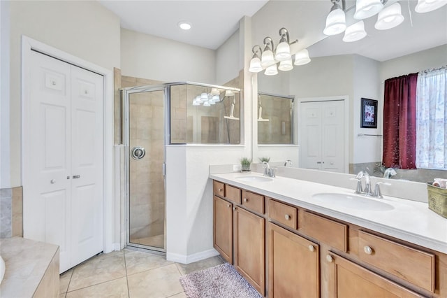 335 River Enclave Ct, Bradenton, FL 34212 - bathroom featuring a shower stall, double vanity, tile patterned floors, and a closet
