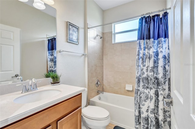 full bathroom with vanity, shower / tub combo, and toilet