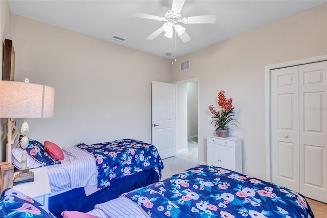 bedroom featuring a closet, ceiling fan, and light colored carpet