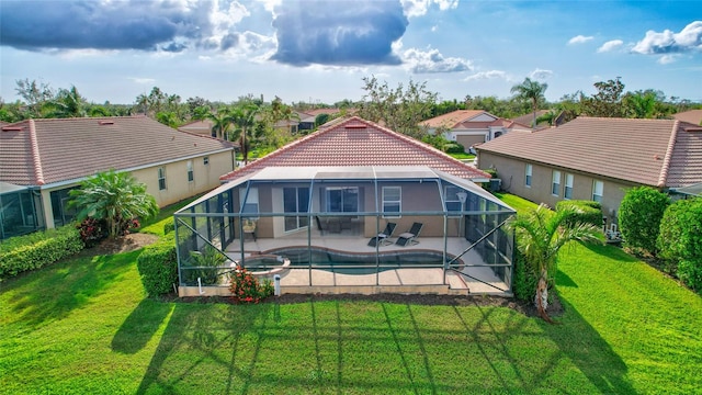 rear view of house featuring a yard, glass enclosure, and a patio area