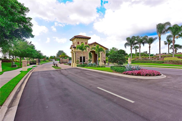 335 River Enclave Ct, Bradenton, FL 34212 - view of asphalt street with sidewalks, curbs, and a gated entry