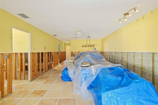 misc room with ceiling fan and light tile patterned flooring