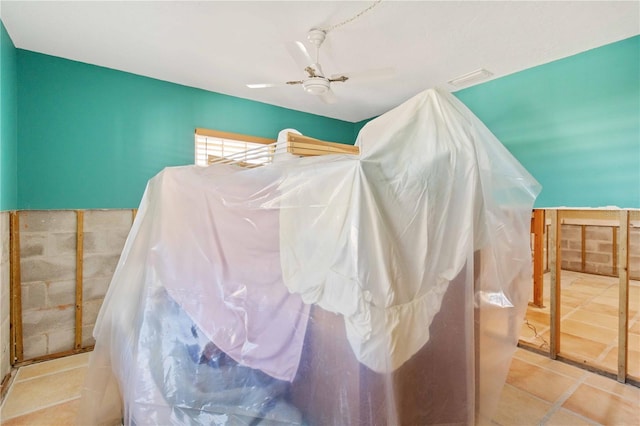 interior space with ceiling fan