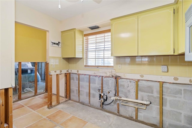 kitchen featuring light tile patterned floors and backsplash