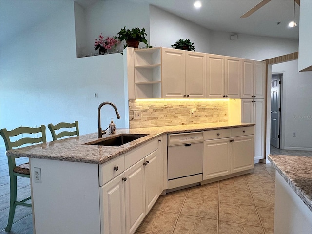 kitchen featuring dishwasher, kitchen peninsula, white cabinetry, and sink