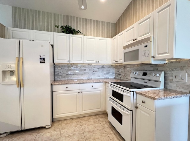 kitchen featuring white cabinets, white appliances, tasteful backsplash, and light stone countertops