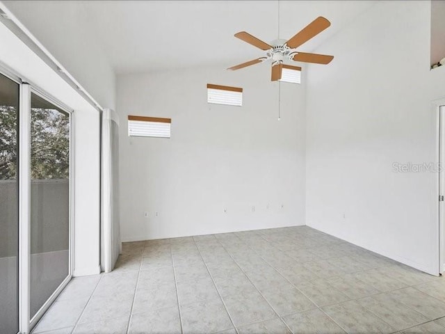 tiled empty room with high vaulted ceiling and ceiling fan