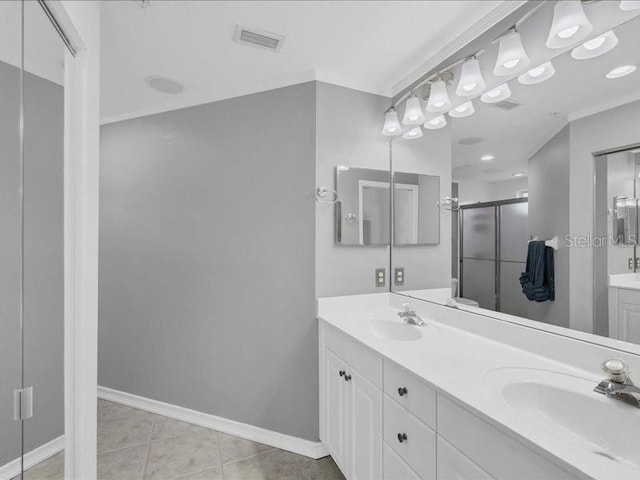 bathroom featuring tile patterned floors, vanity, and a shower with shower door