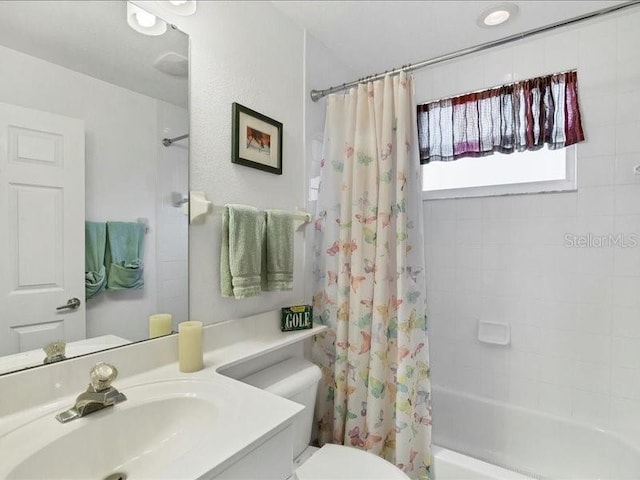 full bathroom featuring vanity, toilet, and shower / bath combo with shower curtain