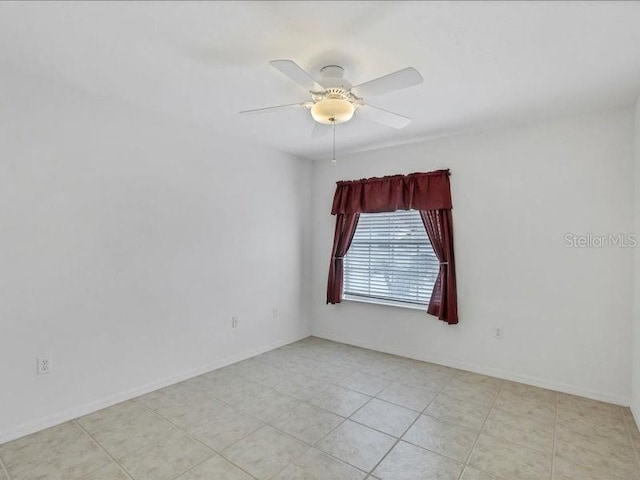 unfurnished room featuring ceiling fan and light tile patterned flooring