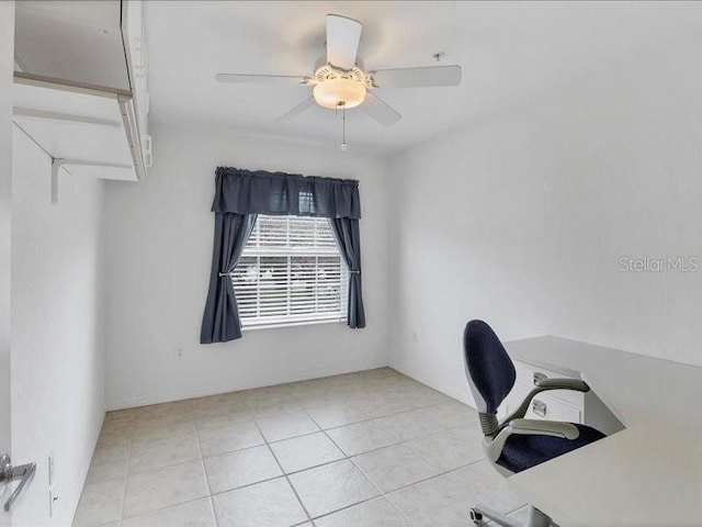 unfurnished office with ceiling fan and light tile patterned flooring