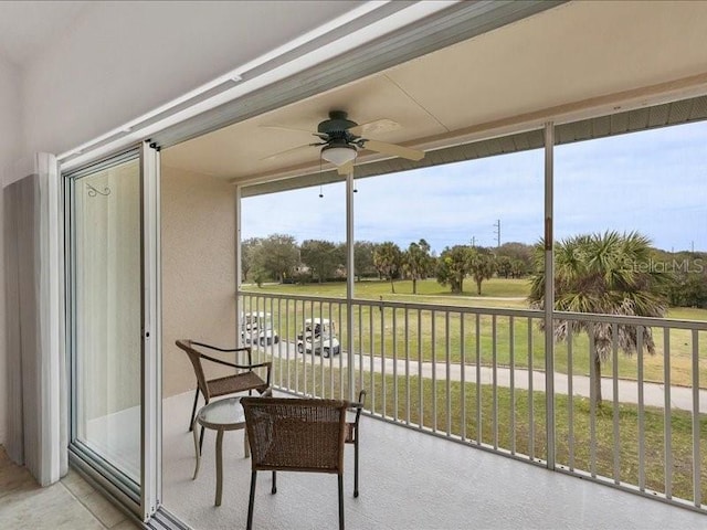 sunroom / solarium featuring ceiling fan