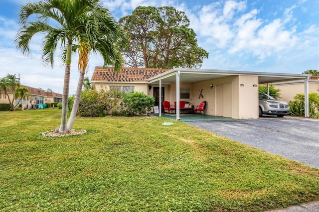 view of front of property with a carport and a front yard