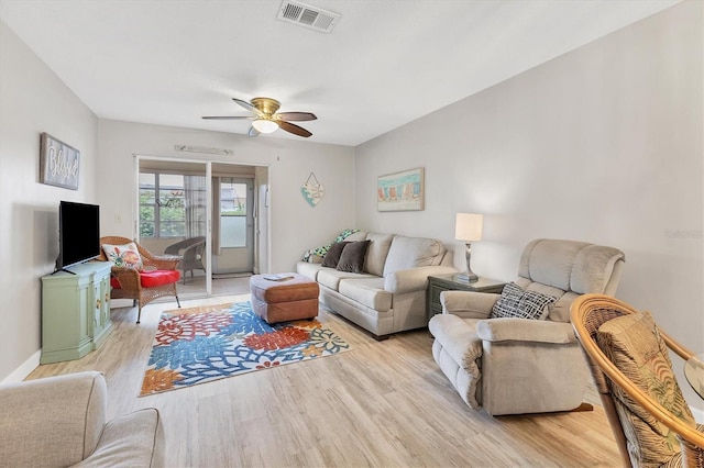 living area with light wood finished floors and a ceiling fan